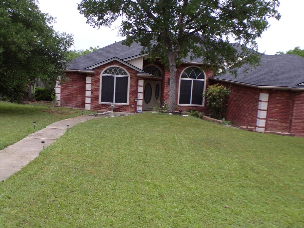 front view of a house with a garden