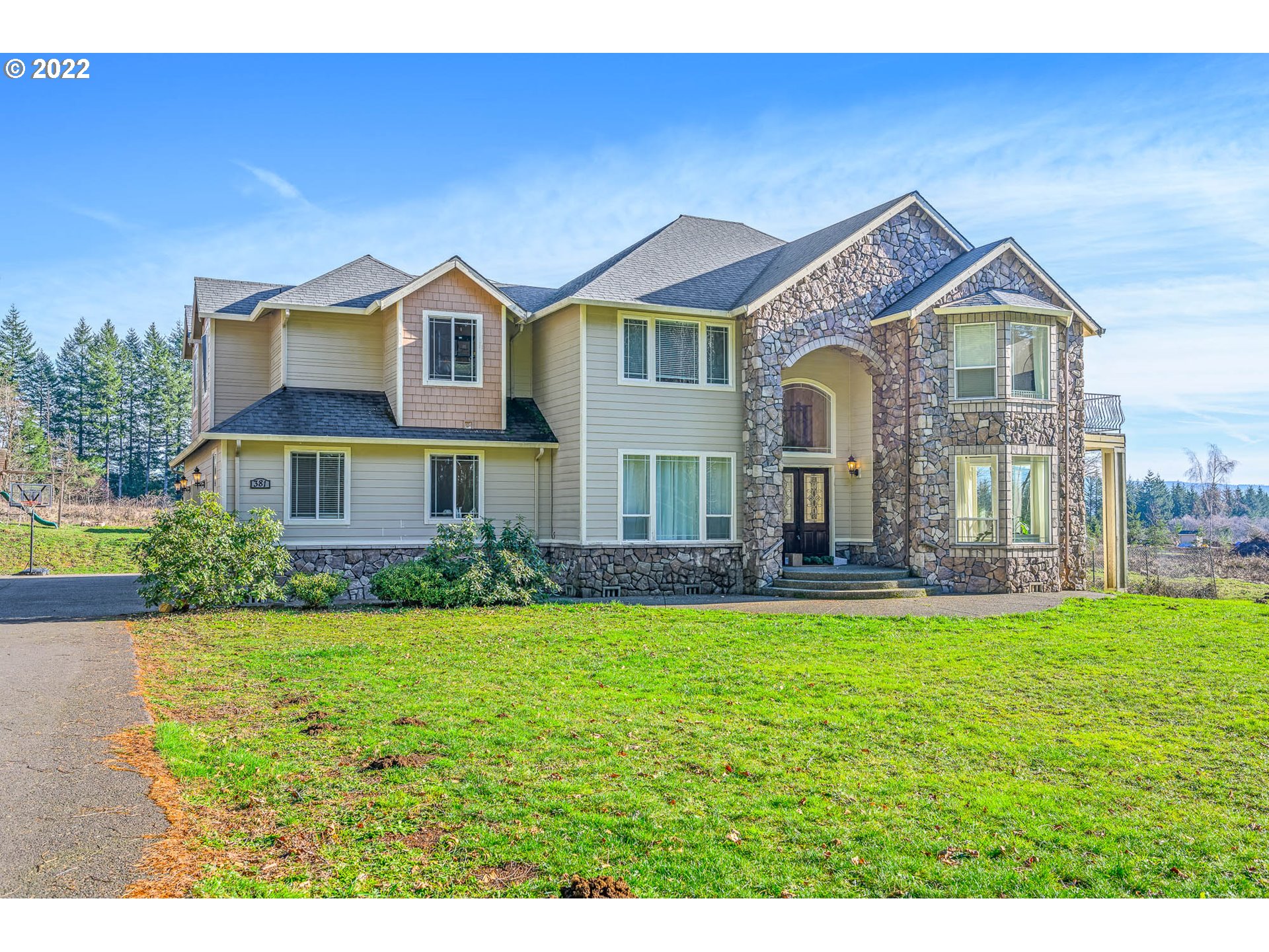 a front view of house with yard and green space