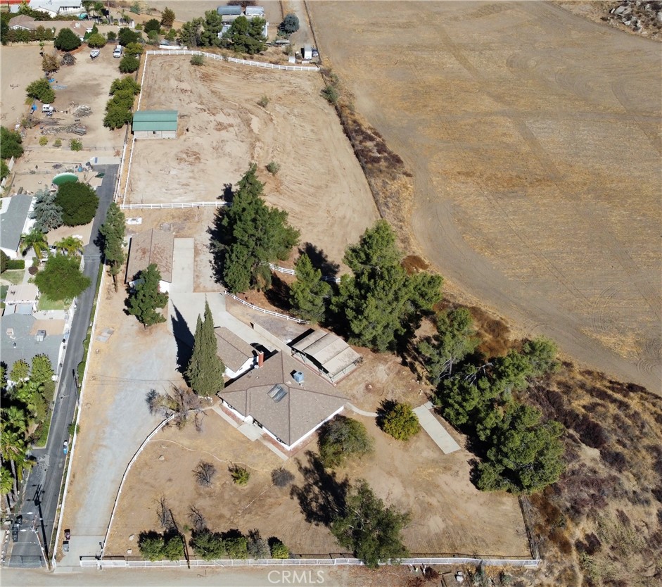 an aerial view of a house with a yard and lake view