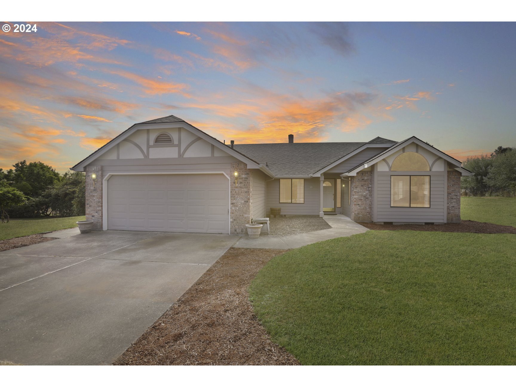 a front view of a house with a yard and garage