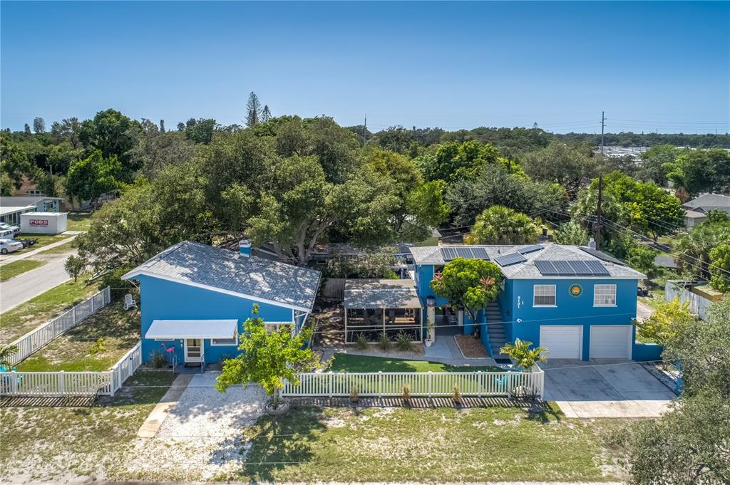 an aerial view of a house with a big yard