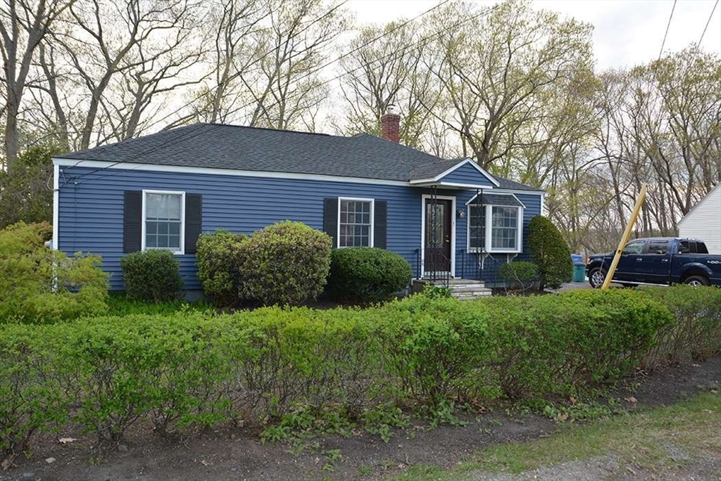 a front view of house with yard and green space