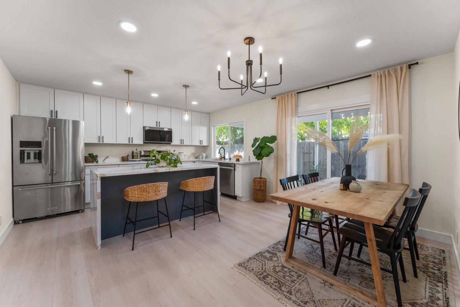 a kitchen with a dining table chairs appliances and cabinets