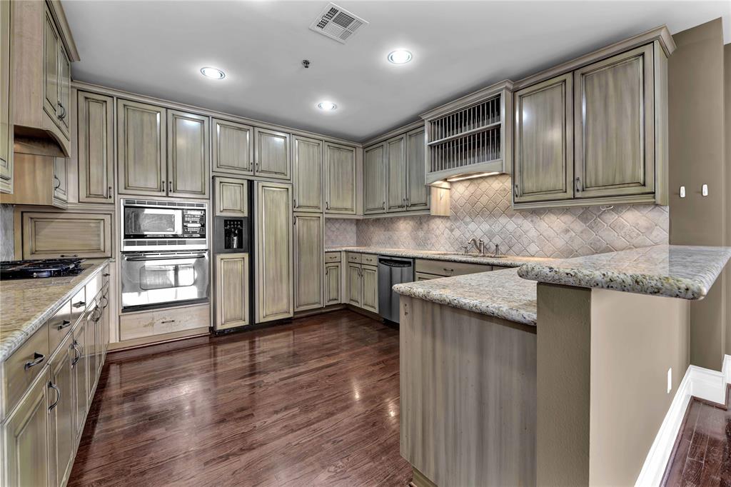 a kitchen with granite countertop stainless steel appliances and wooden cabinets