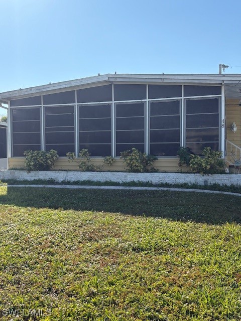 a view of house with a yard