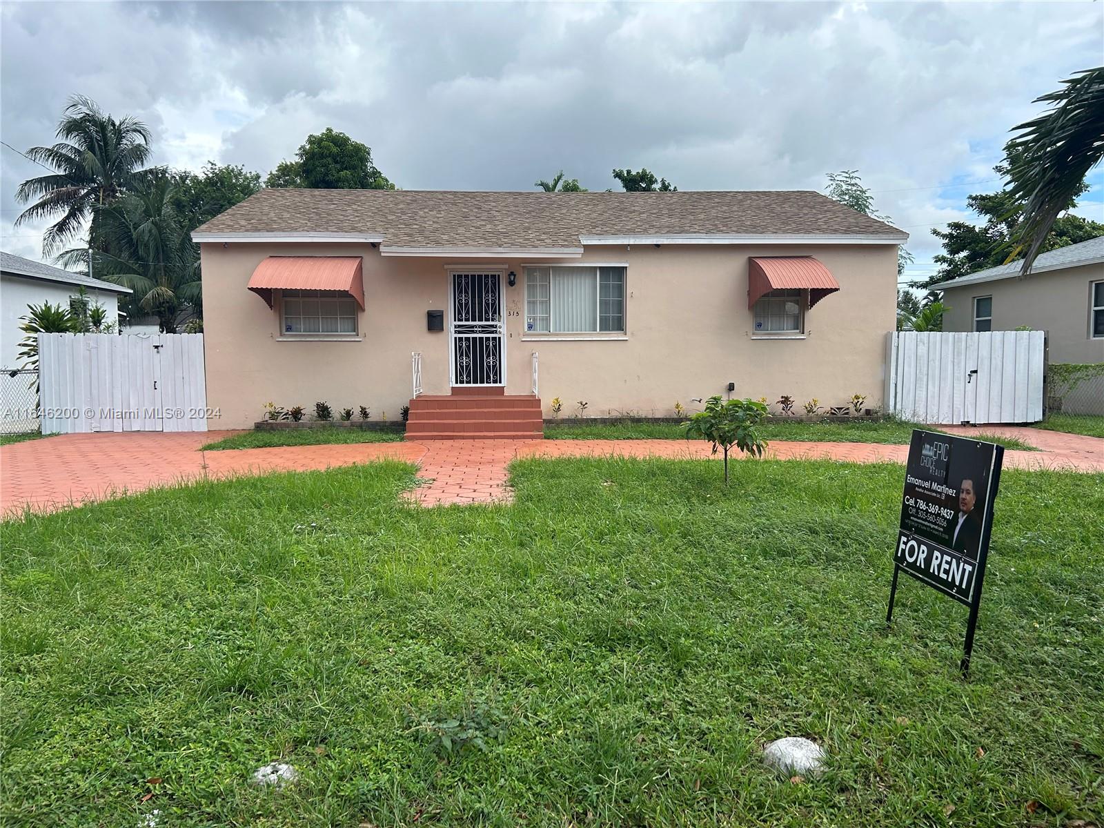 a front view of house with yard and outdoor seating