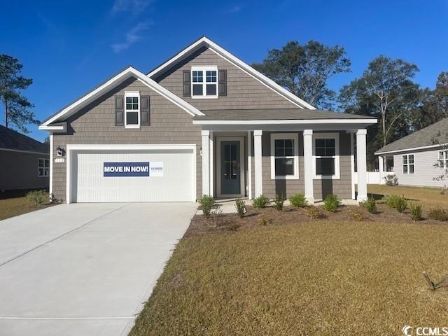 Craftsman-style home with a garage and a front law