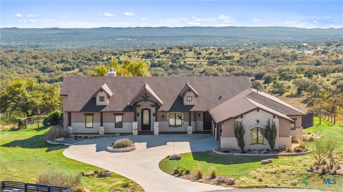 an aerial view of a house with outdoor space and a lake view