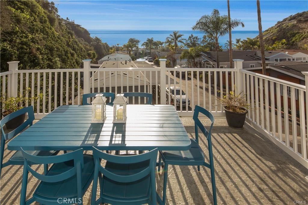 a view of a deck with two chairs and a table