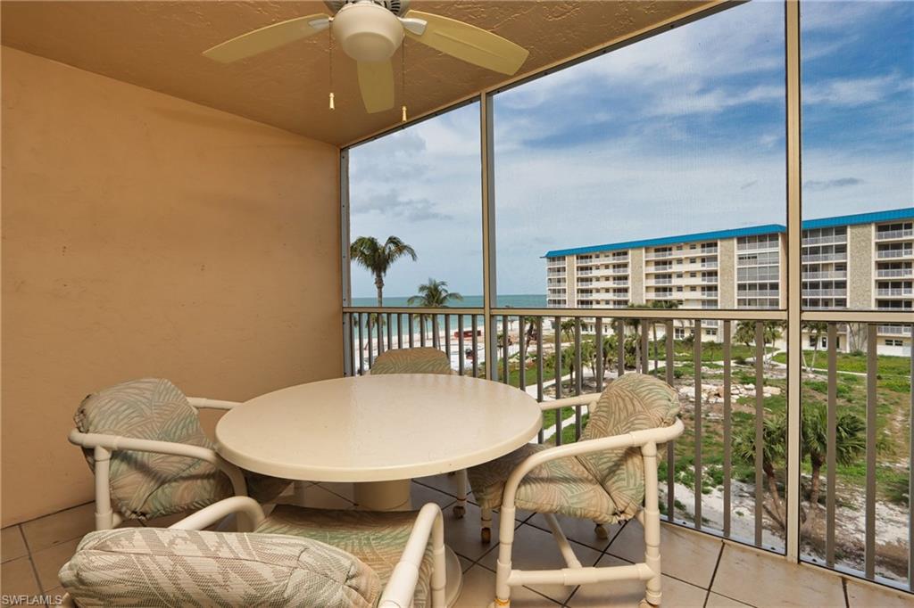 a view of a balcony dining table and chairs