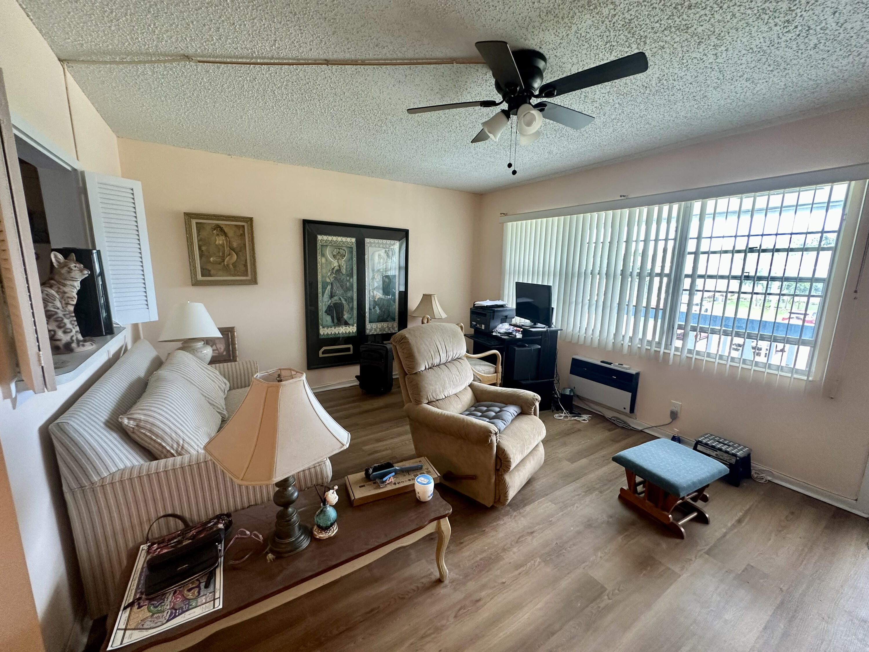 a living room with furniture hardwood floor and a window