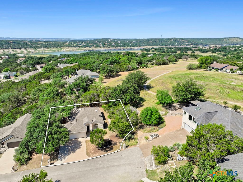 an aerial view of residential houses with outdoor space and river