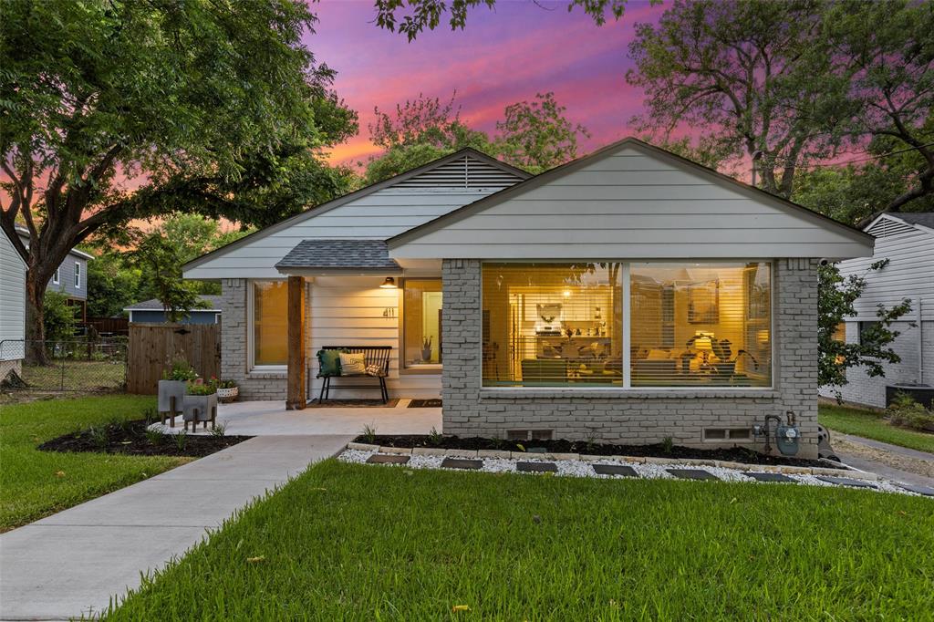 a front view of a house with a yard and outdoor seating