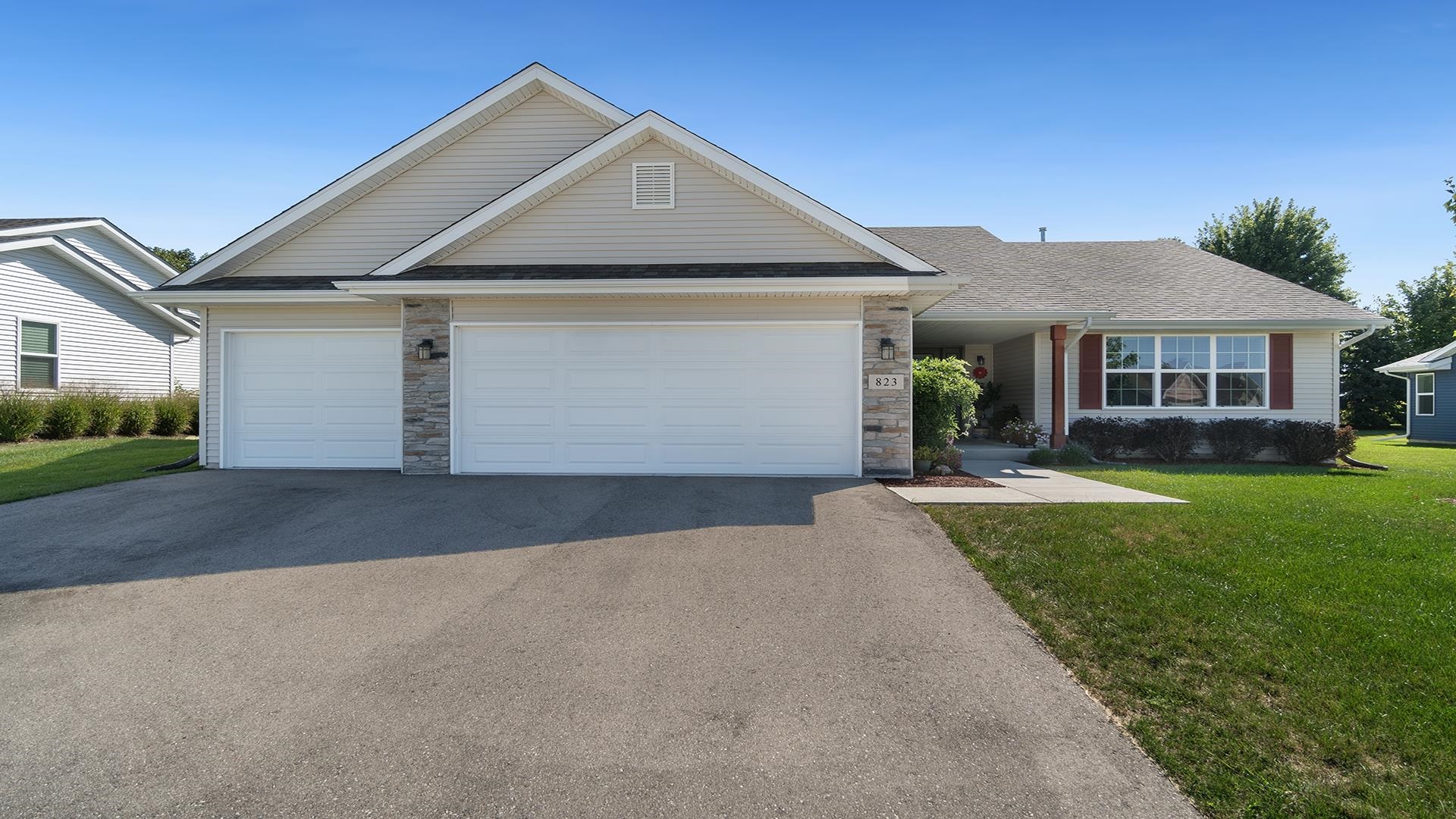 a front view of a house with a yard and garage