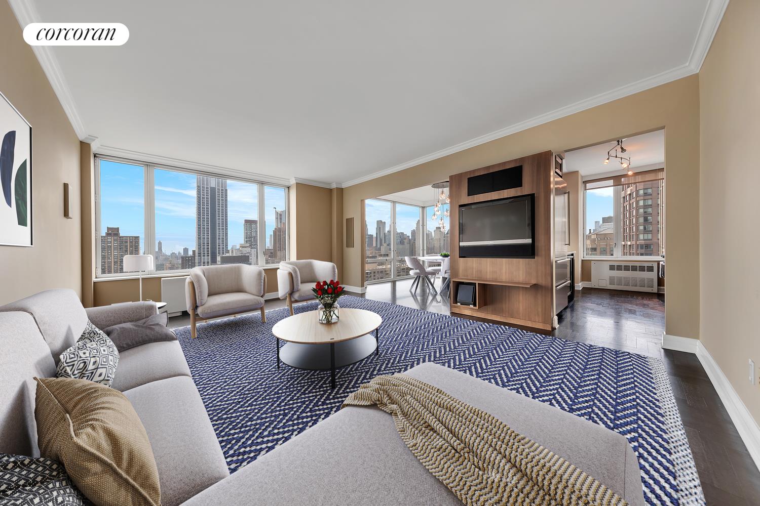 a living room with furniture a flat screen tv and wooden floor