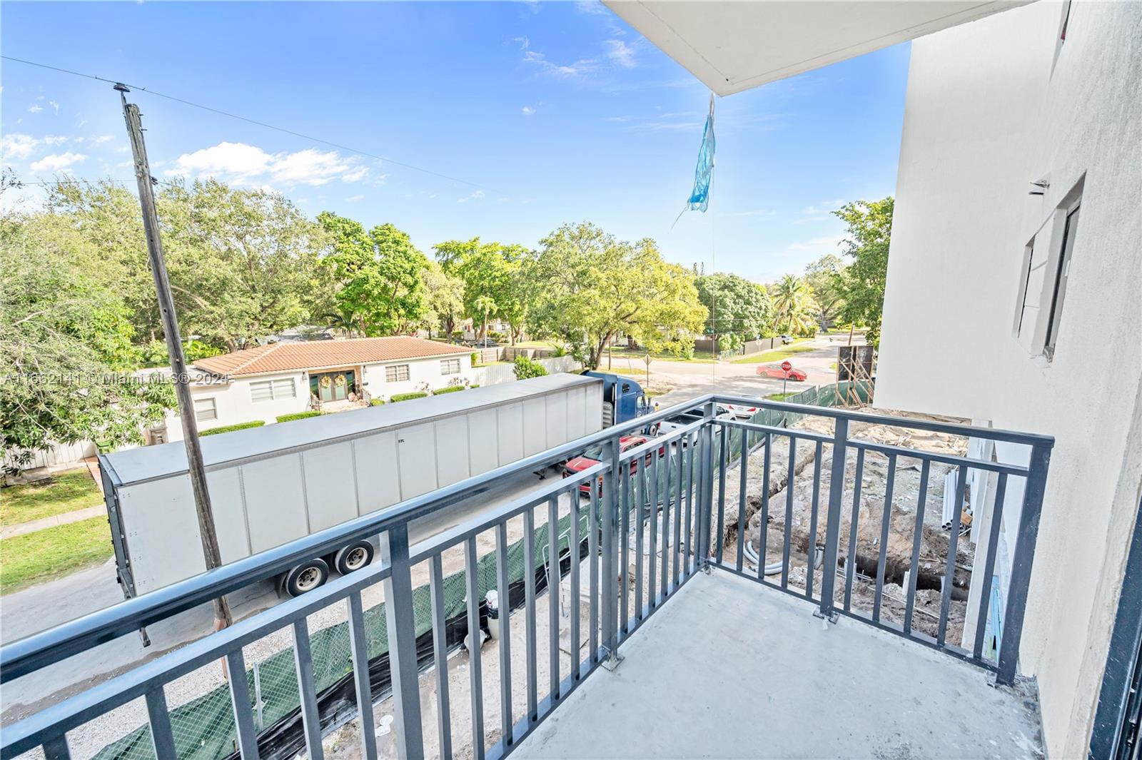 a view of a balcony with wooden floor