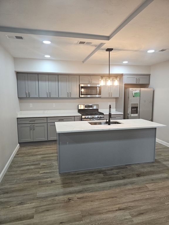 a view of kitchen with stainless steel appliances granite countertop stove top oven and cabinets