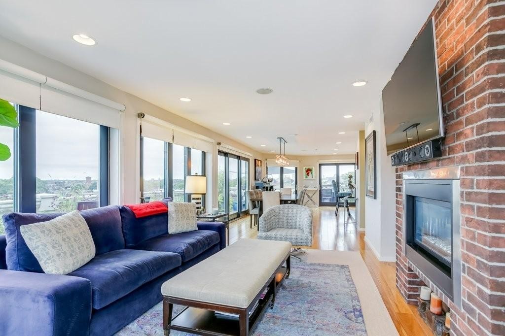 a living room with furniture and a fireplace