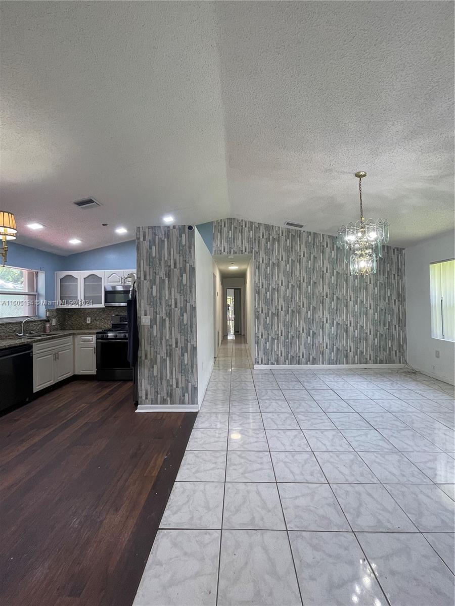 a view of a kitchen with a sink and cabinets