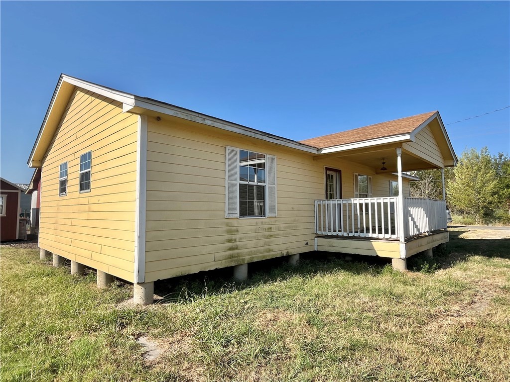 a view of a house with a yard and deck