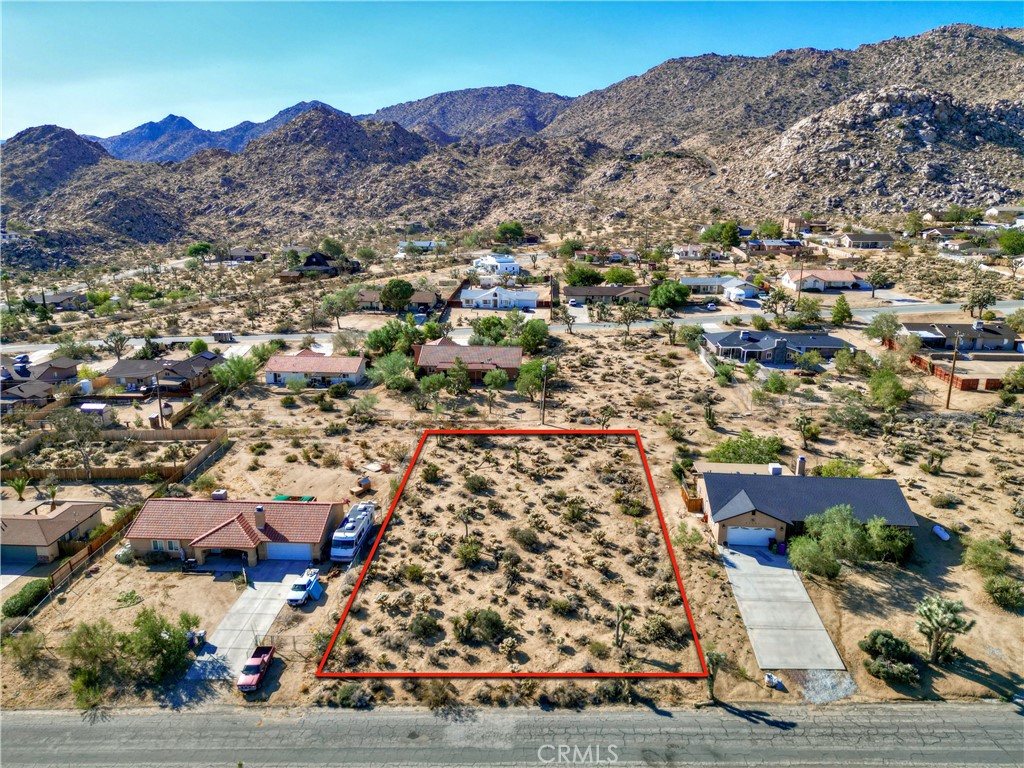 an aerial view of residential house and sandy dunes