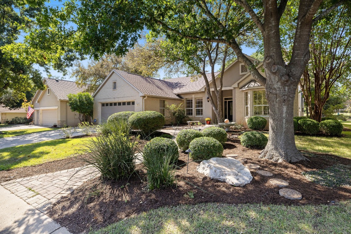 a front view of house with yard and green space