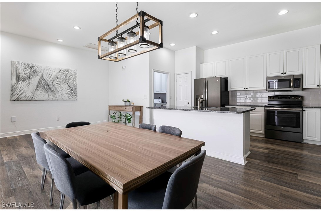 a kitchen with a table and chairs in it