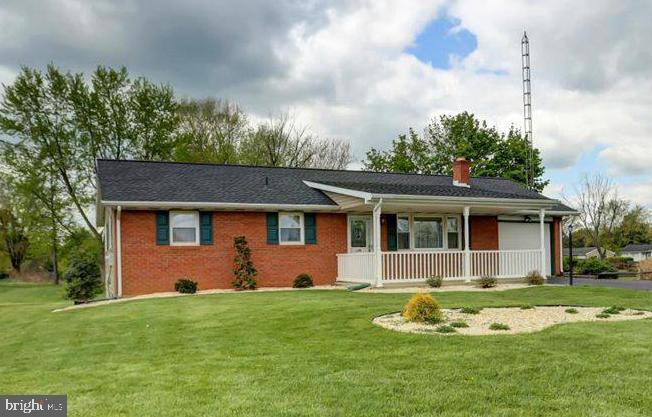 a front view of house with yard and green space