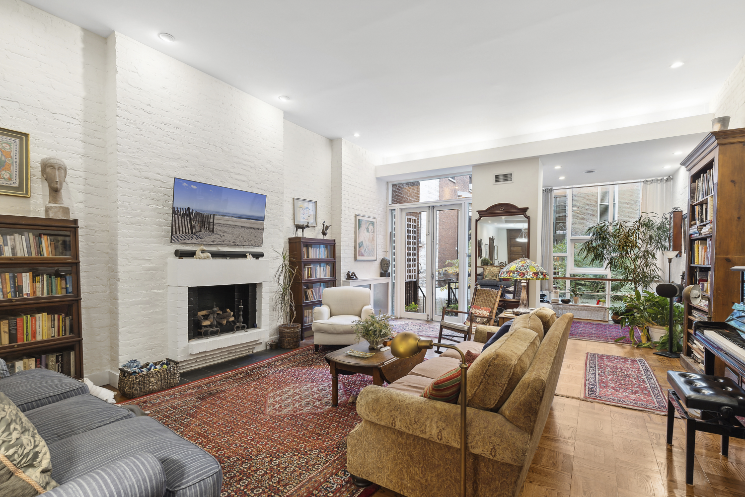 a living room with furniture large window and a fireplace