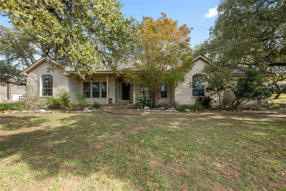 a view of a house with backyard and tree