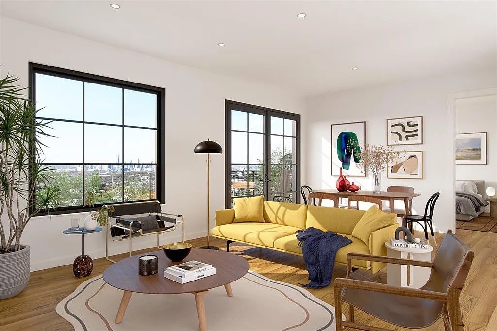 a living room with furniture and floor to ceiling windows