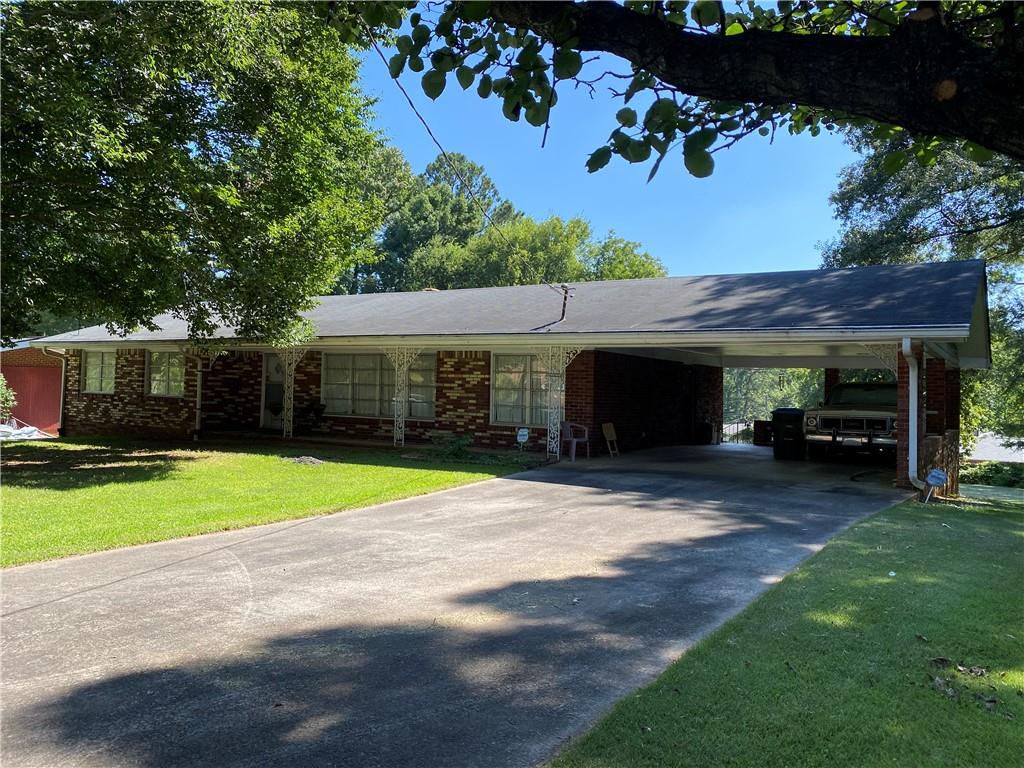 a view of a house with a yard and garage