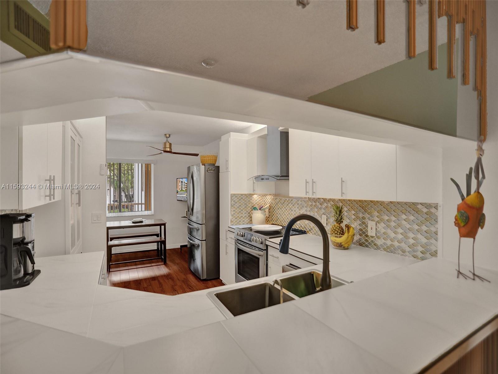 a view of a room with shelves and wooden cabinets