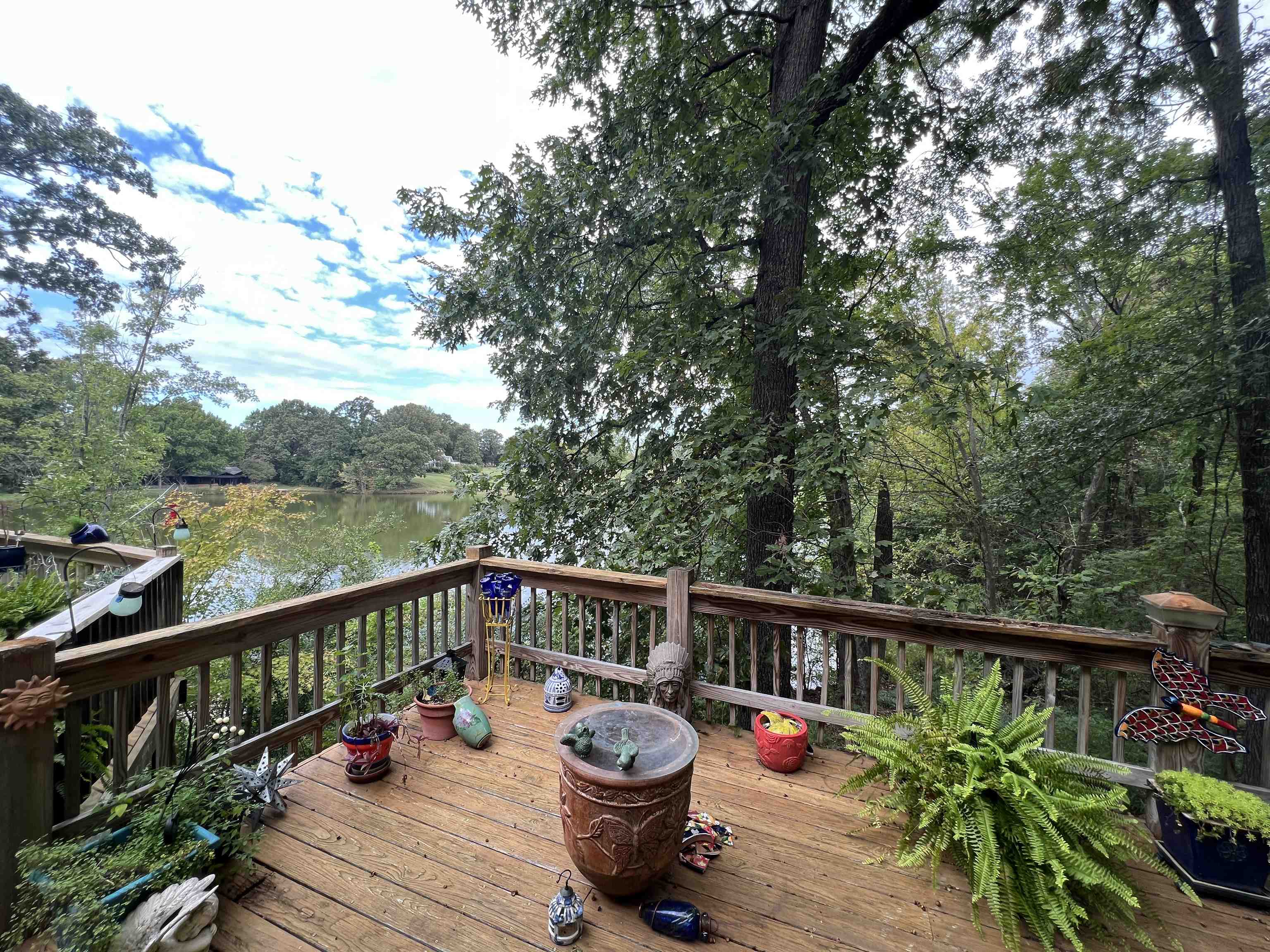 a balcony with wooden floor and barbeque oven