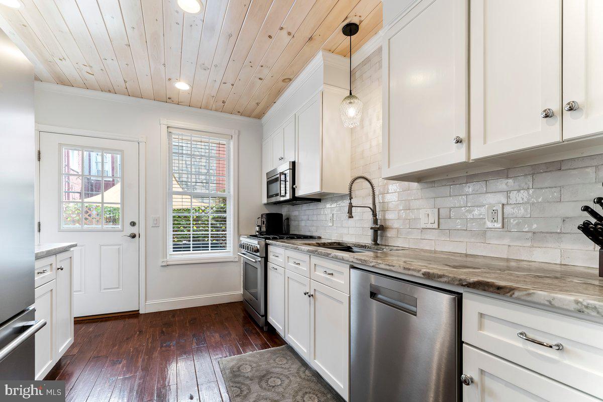 a kitchen with a sink stove and cabinets