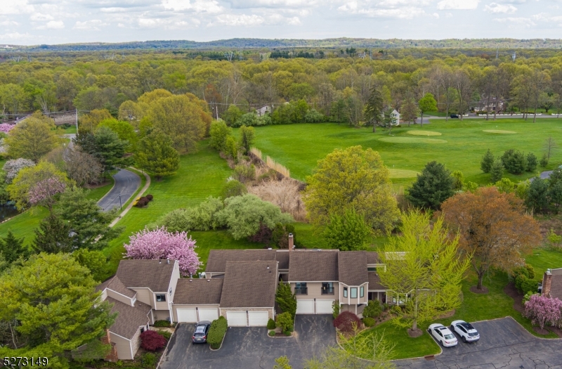 an aerial view of a houses with outdoor space and swimming pool