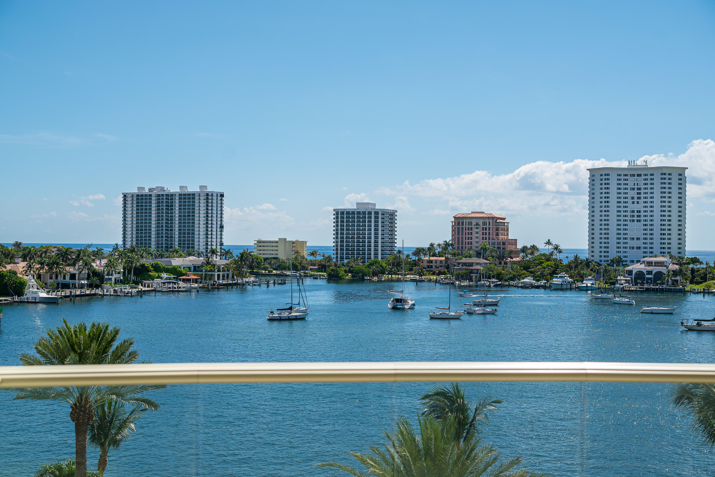 a view of a city with lawn chairs and lake view