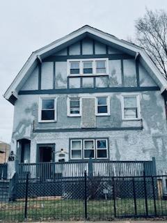 a front view of a house with iron fence