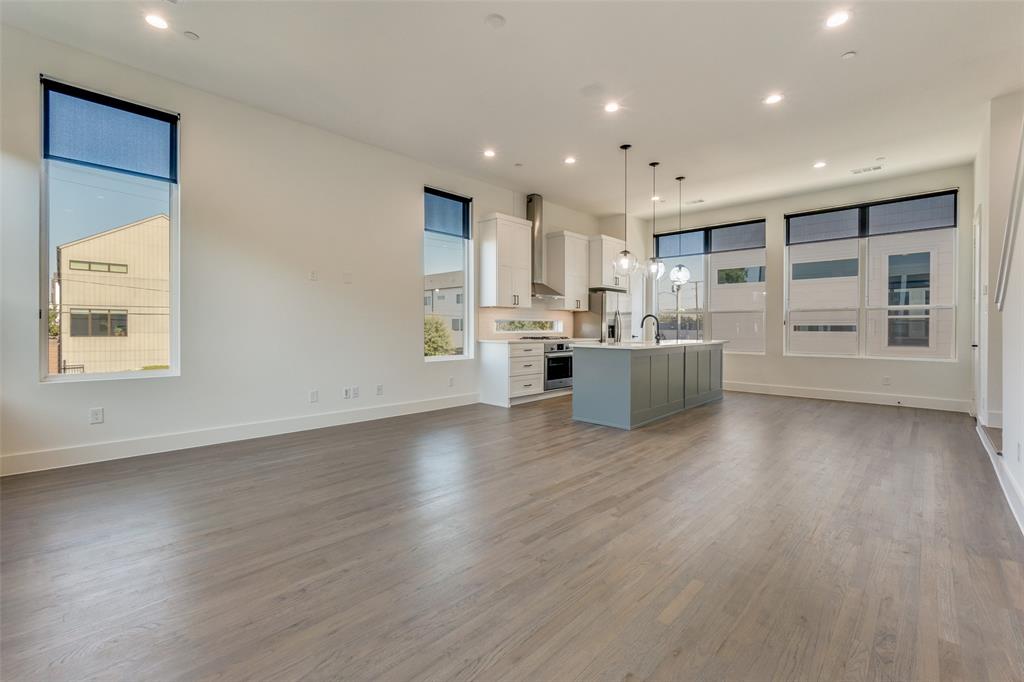 a view of a kitchen with a microwave and wooden floor