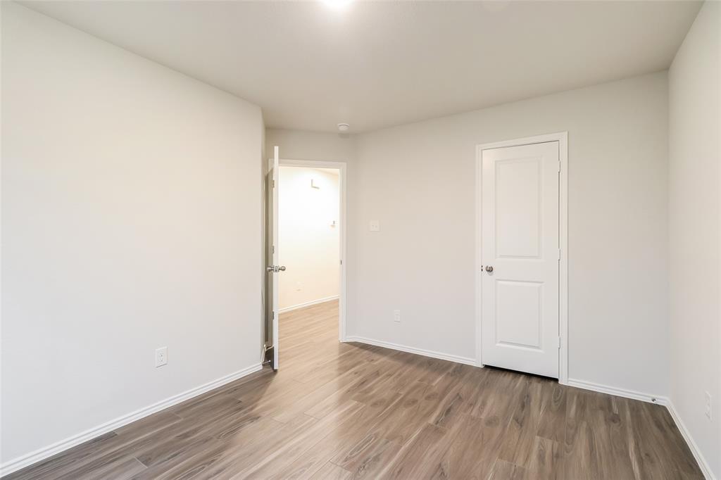 a view of an empty room and wooden floor