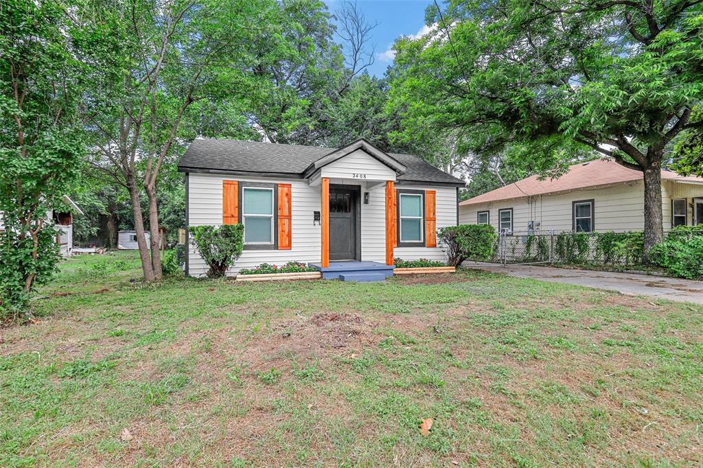 a front view of house with yard and green space