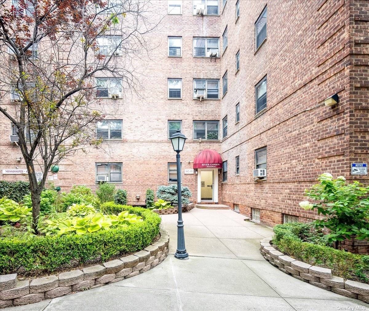 a front view of a building with garden