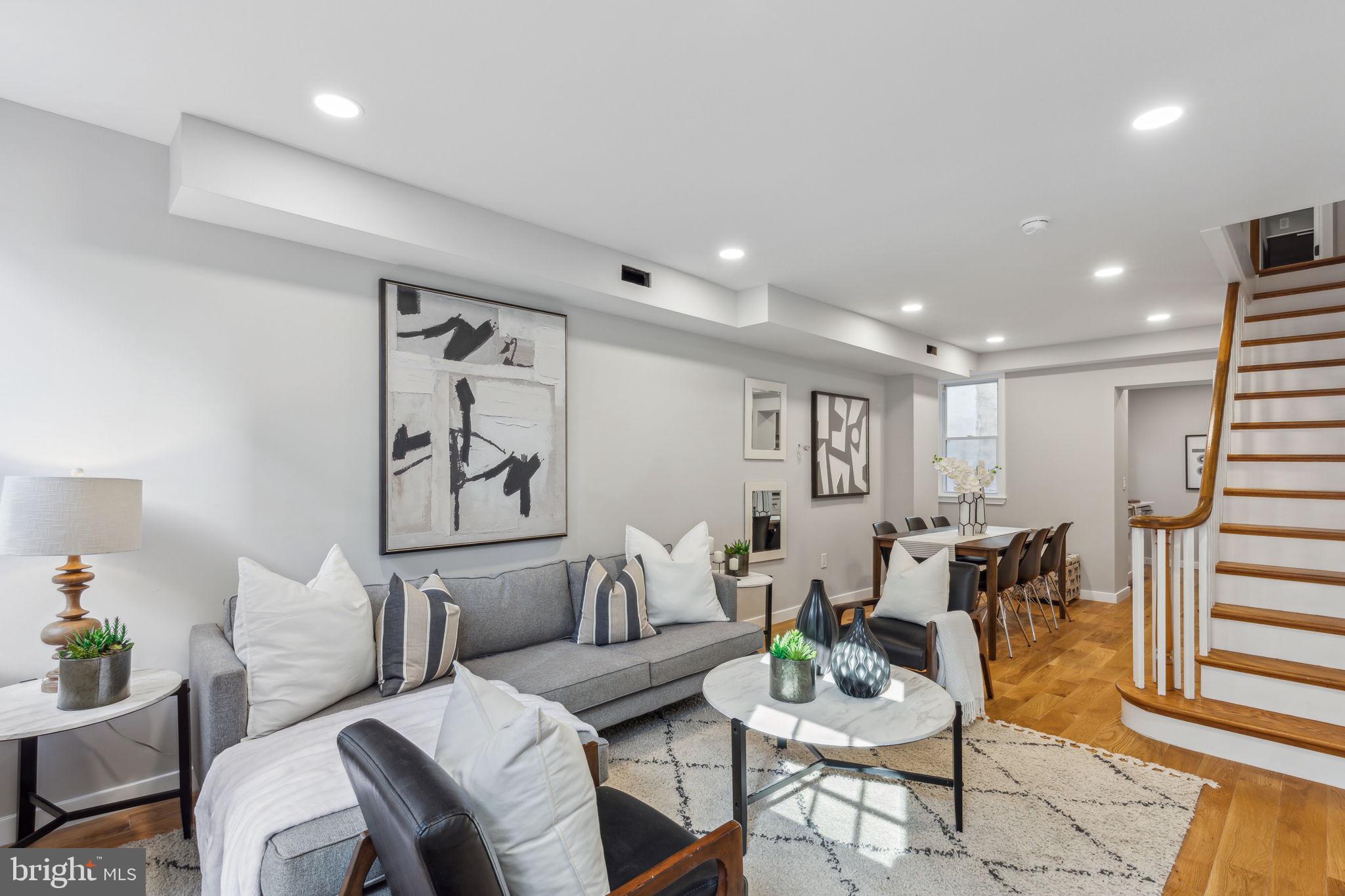 a living room with furniture and wooden floor