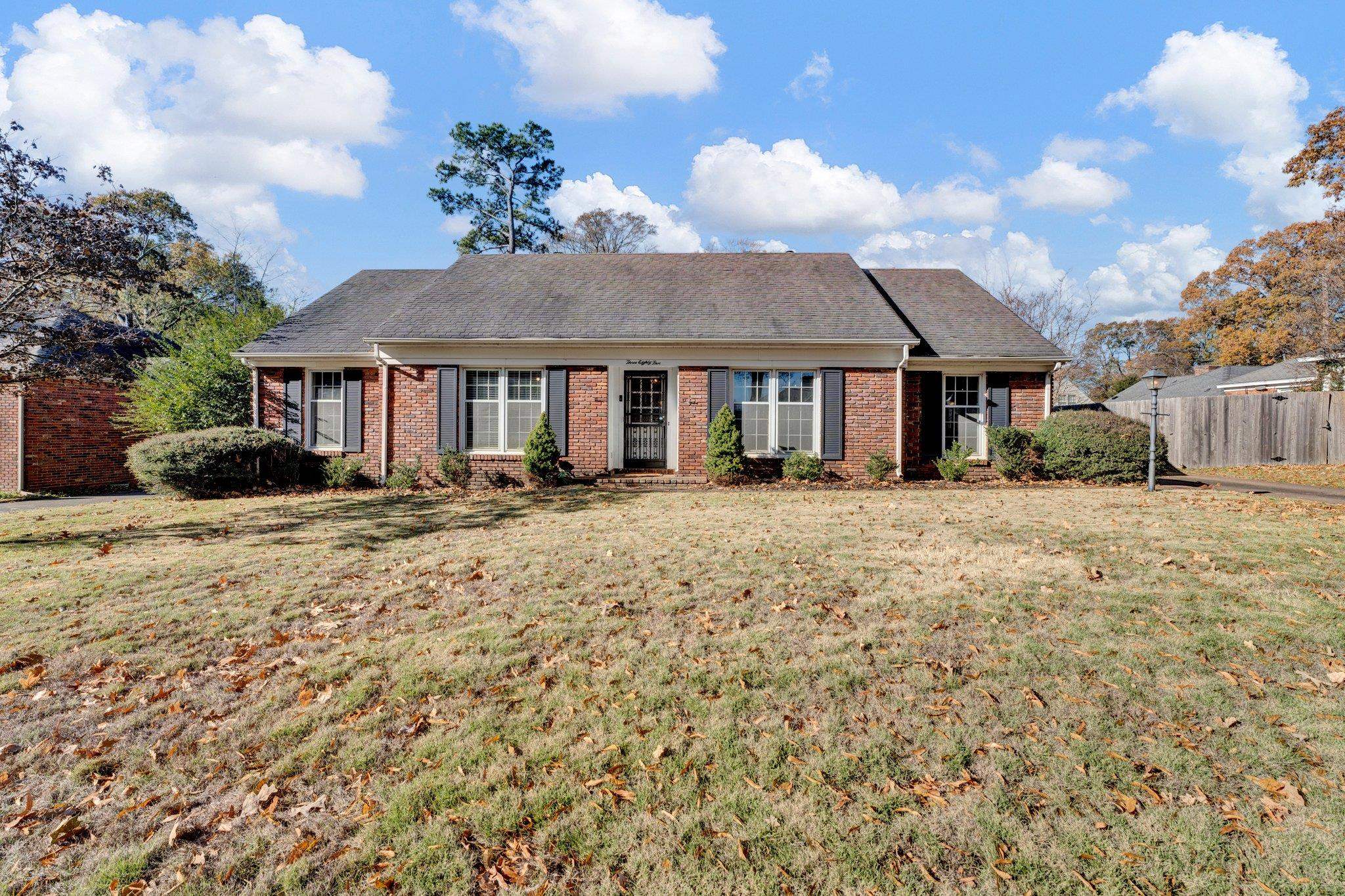 Single story home featuring a front lawn