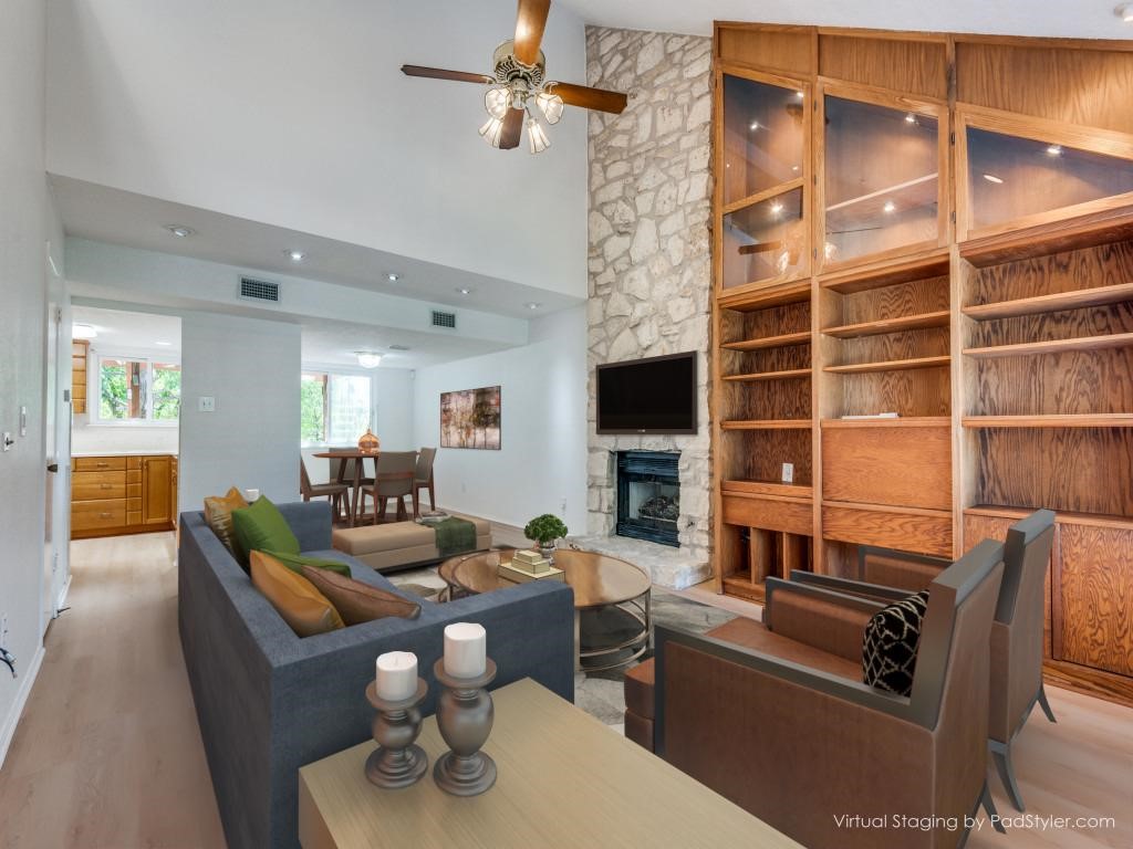 a living room with furniture a flat screen tv and a fireplace