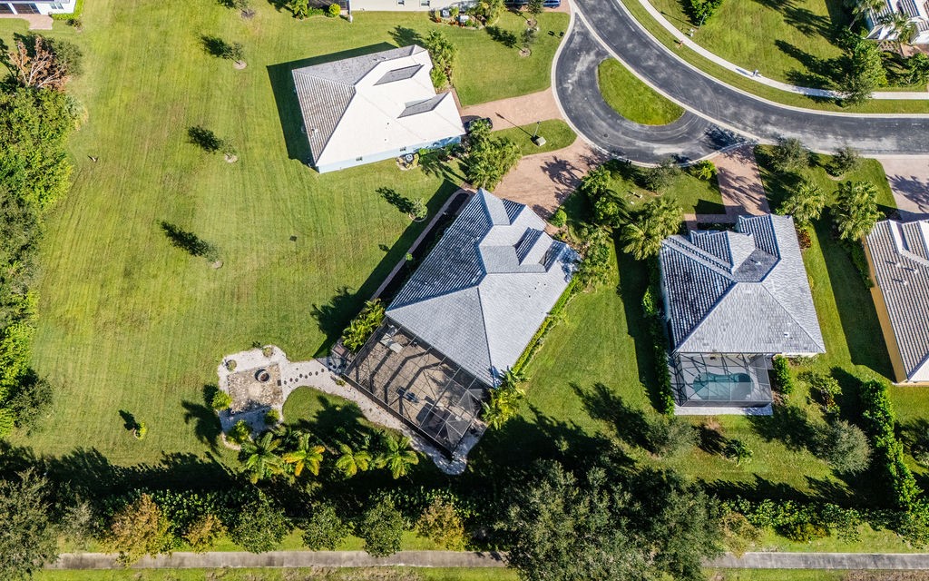 an aerial view of a house with a garden and swimming pool