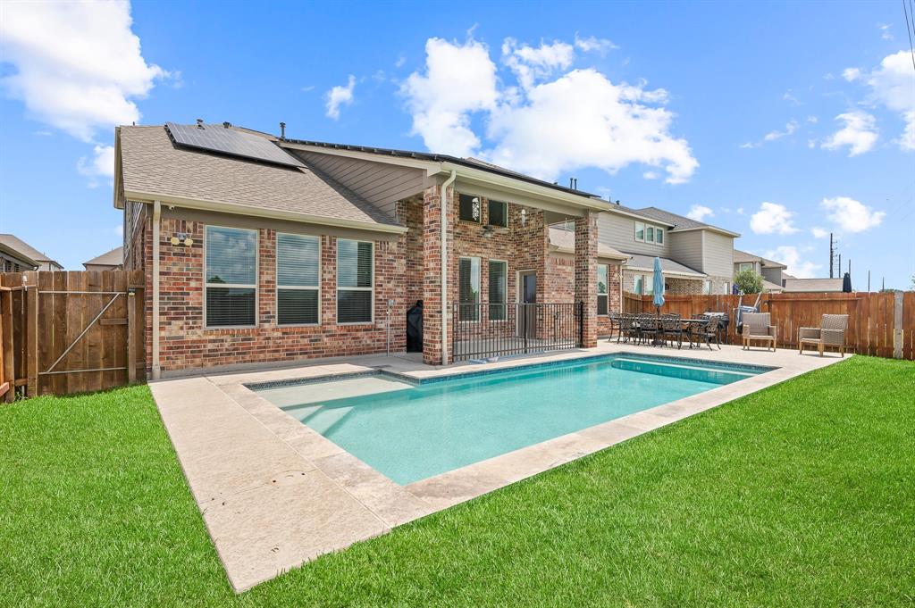 a view of a house with a backyard and a patio