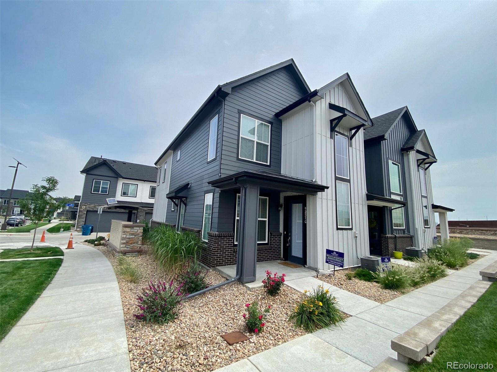 a front view of a house with a yard outdoor seating and plants