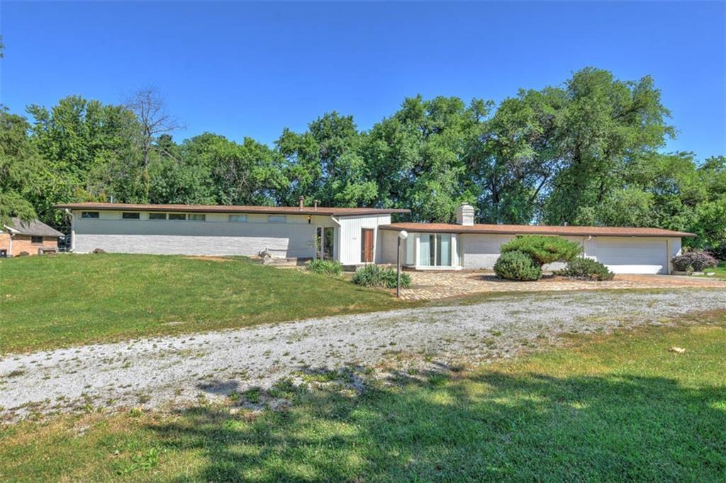 a view of backyard of house with green space