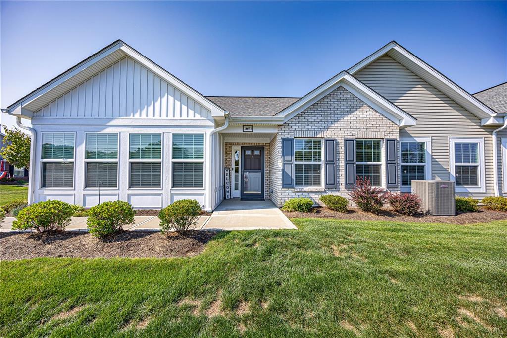 a front view of a house with yard and green space